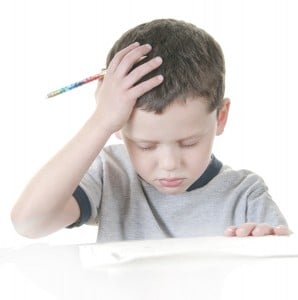 young boy showing stress with school work